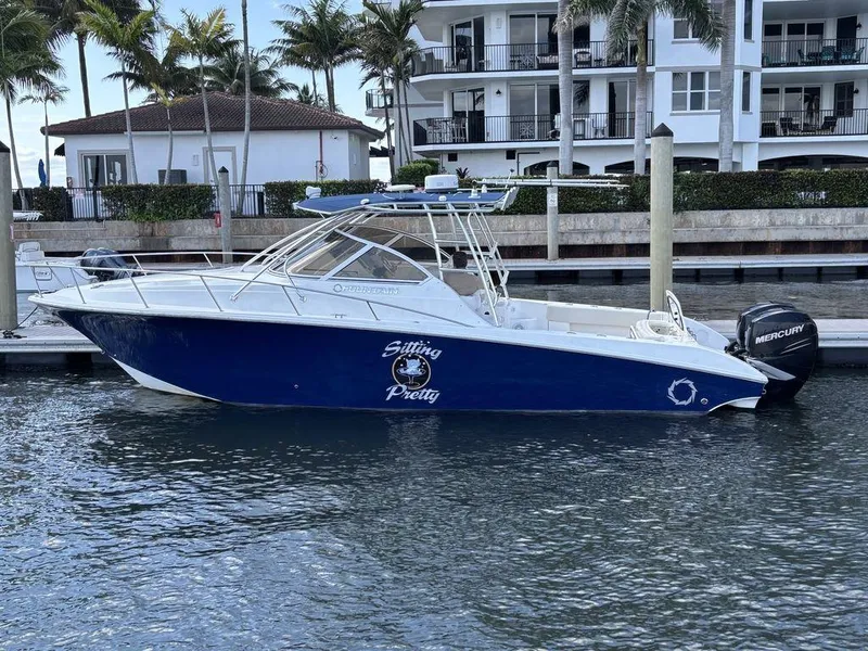 Slide: The Image of 2008 Fountain 33 Sportfish Cruiser docked near waterfront homes. - 30
