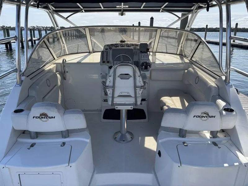 Slide: The Image of 2008 Fountain 33 Sportfish Cruiser interior with helm, seating, and waterfront view. - 4