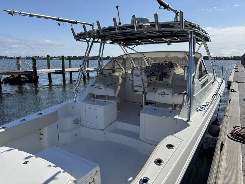 Slide: The Image of 2008 Fountain 33 Sportfish Cruiser docked, showcasing spacious deck and seating. - 6