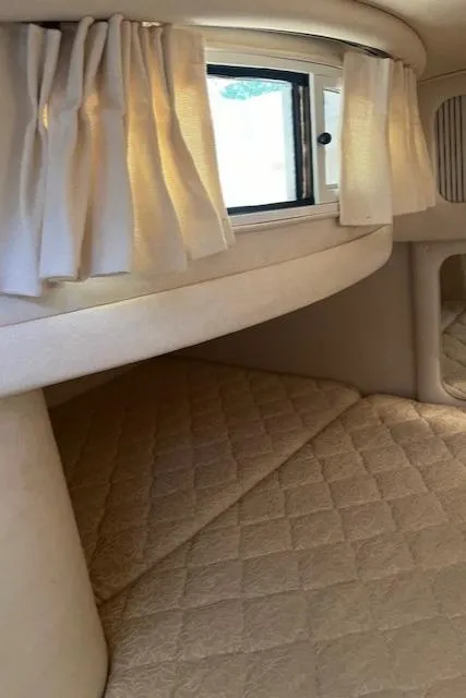 Slide: The Image of Interior cabin of 2001 Sea Ray 290 Sundancer with window and curtains. - 11