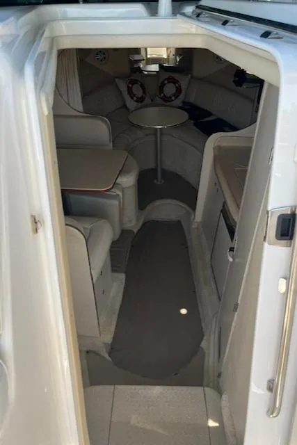 Slide: The Image of Interior view of 2001 Sea Ray 290 Sundancer cabin with seating and table. - 13