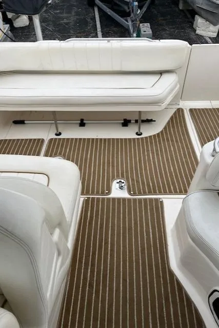 Slide: The Image of 2001 Sea Ray 290 Sundancer interior with white seating and striped flooring. - 15