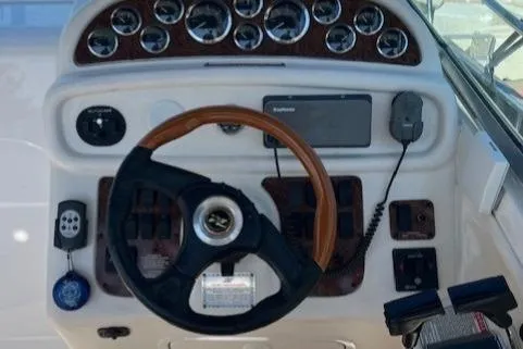 Slide: The Image of Dashboard of a 2001 Sea Ray 290 Sundancer boat with steering wheel and gauges. - 7