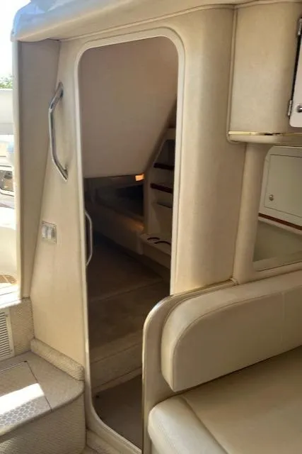 Slide: The Image of 2001 Sea Ray 290 Sundancer cabin interior with beige seating and compact design. - 9