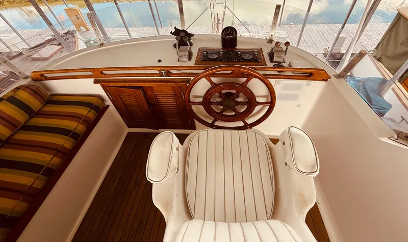 Slide: The Image of 1980 C & L Sea Ranger helm with wooden wheel and striped seating. - 10