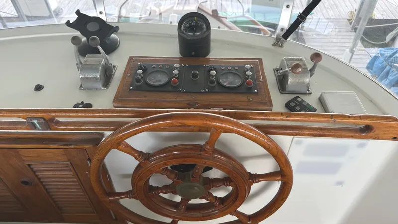 Slide: The Image of Wooden helm of 1980 C & L Sea Ranger boat with control panel and instruments. - 11