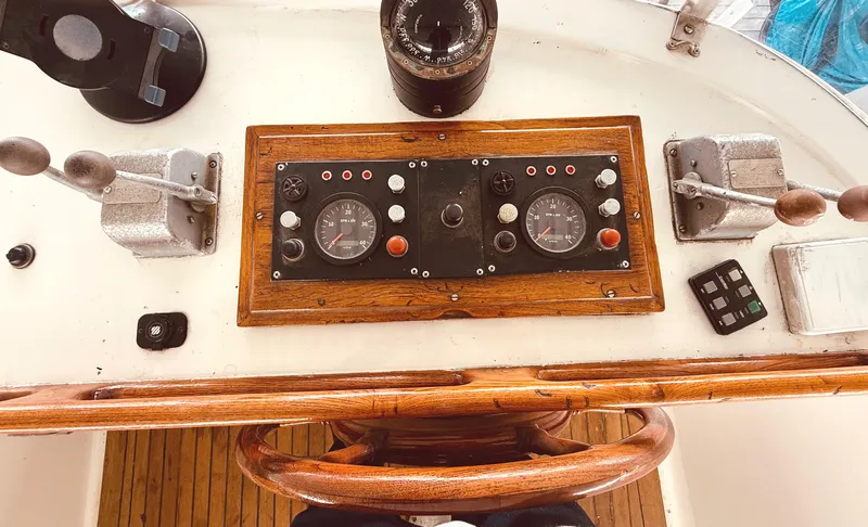 Slide: The Image of 1980 C & L Sea Ranger boat dashboard with wooden steering wheel and control panel. - 12