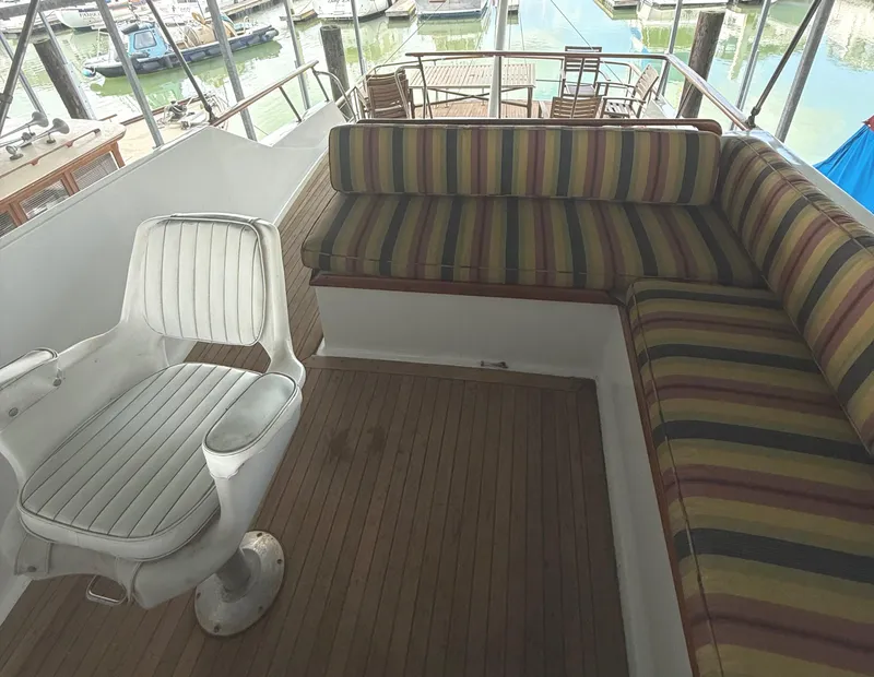 Slide: The Image of 1980 C & L Sea Ranger yacht interior with striped seating and white captain's chair. - 13