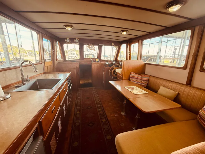 Slide: The Image of Interior of 1980 C & L Sea Ranger boat with kitchen and seating area. - 15
