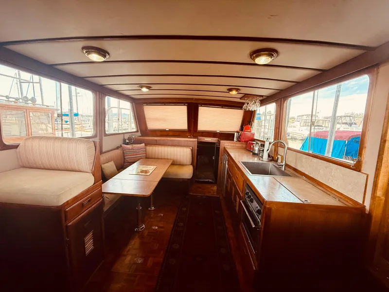 Slide: The Image of Interior of 1980 C & L Sea Ranger boat with kitchen and seating area. - 17