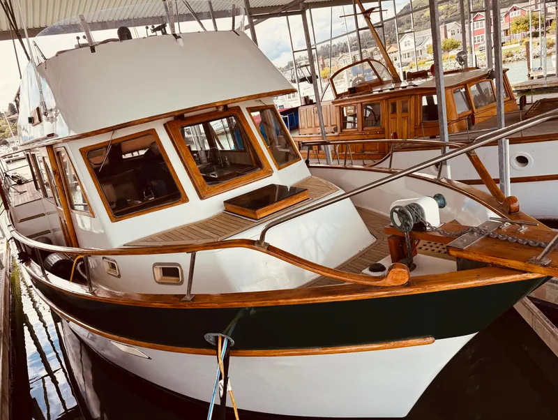Slide: The Image of 1980 C & L Sea Ranger boat docked under a covered marina. - 2