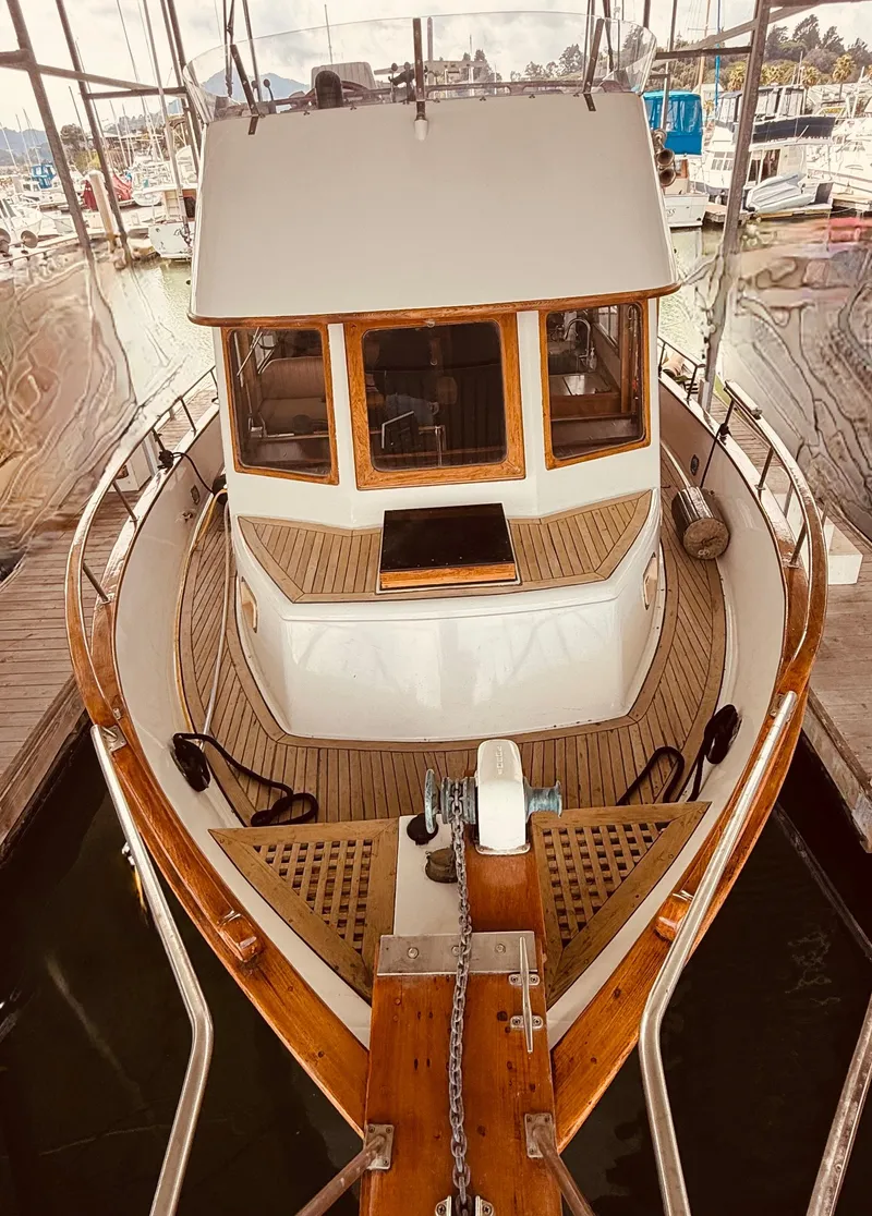 Slide: The Image of 1980 C & L Sea Ranger boat docked, featuring wooden deck and classic design. - 3