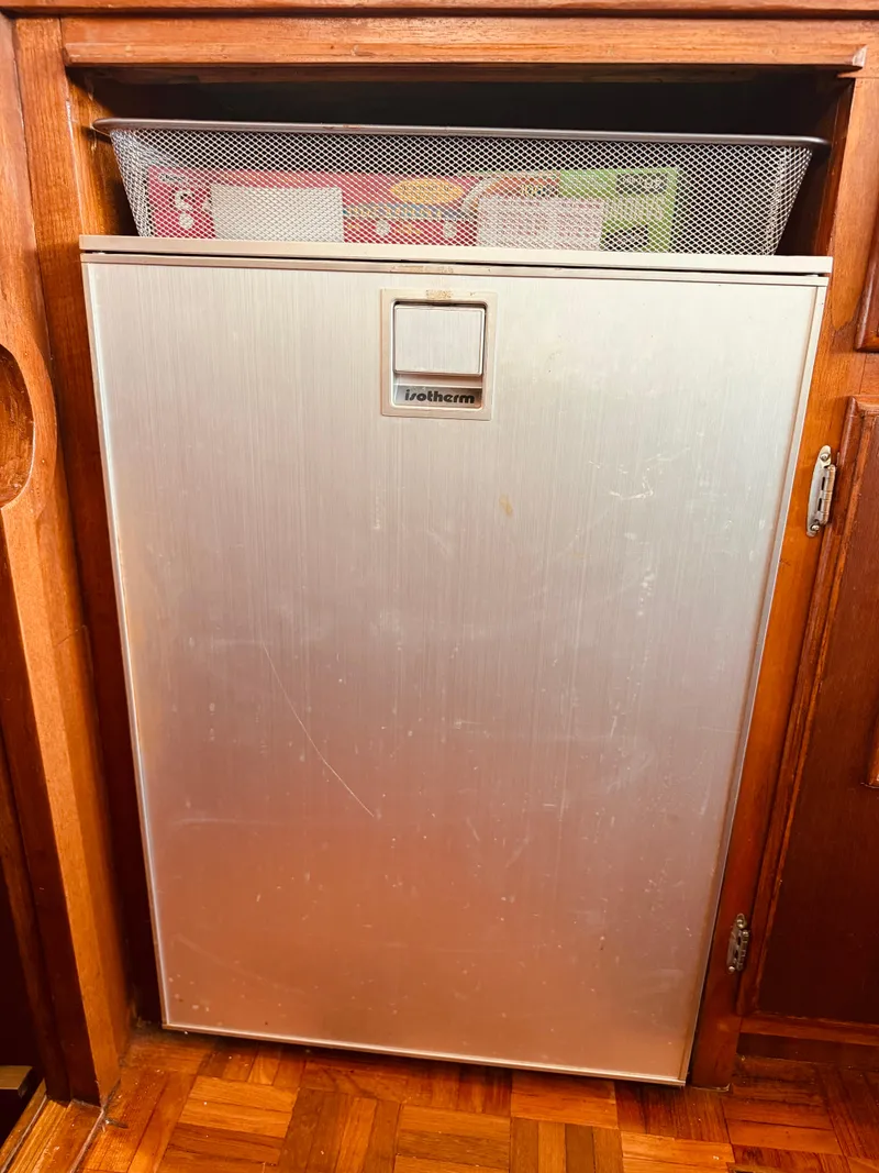 Slide: The Image of Vintage 1980 C & L Sea Ranger refrigerator with wooden cabinetry and storage above. - 30