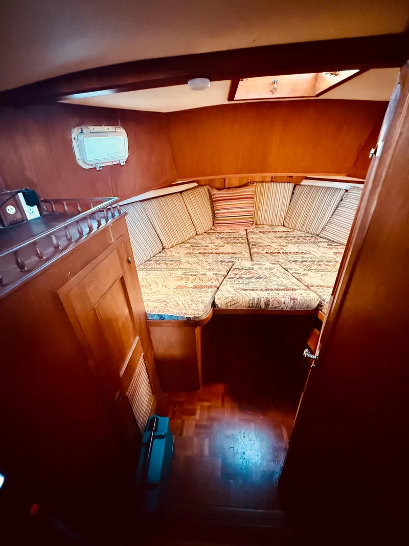 Slide: The Image of Cozy cabin interior of 1980 C & L Sea Ranger boat with cushioned seating. - 33