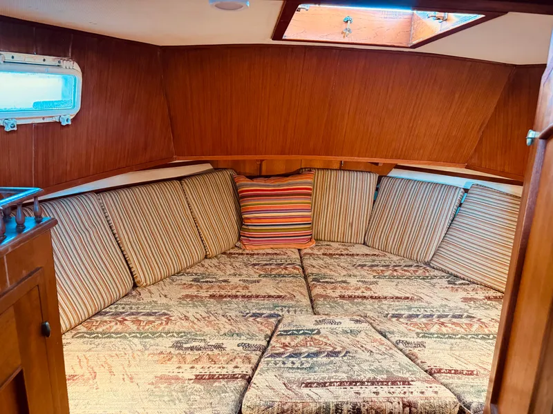 Slide: The Image of 1980 C & L Sea Ranger cabin with striped cushions and wooden interior. - 34