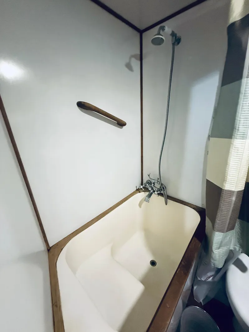 Slide: The Image of Compact bathroom with shower and tub on a 1980 C & L Sea Ranger boat. - 37