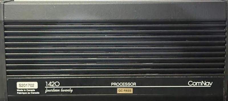 Slide: The Image of ComNav 1420 Processor, black casing, made in Canada, QC Pass label. - 40
