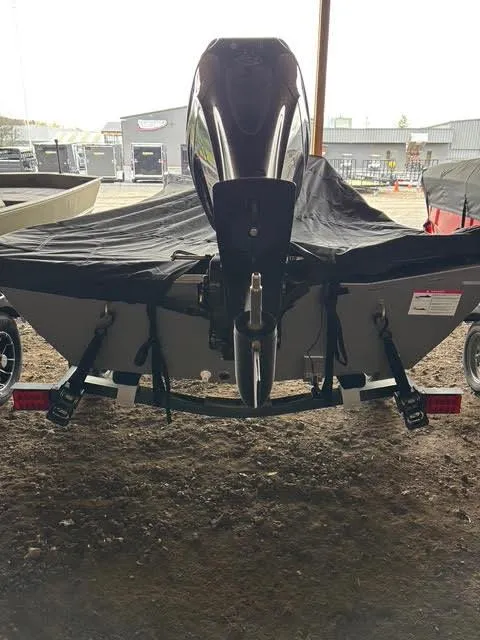 Slide: The Image of 2025 Lowe Skorpion 16 boat with cover and motor, parked indoors. - 10