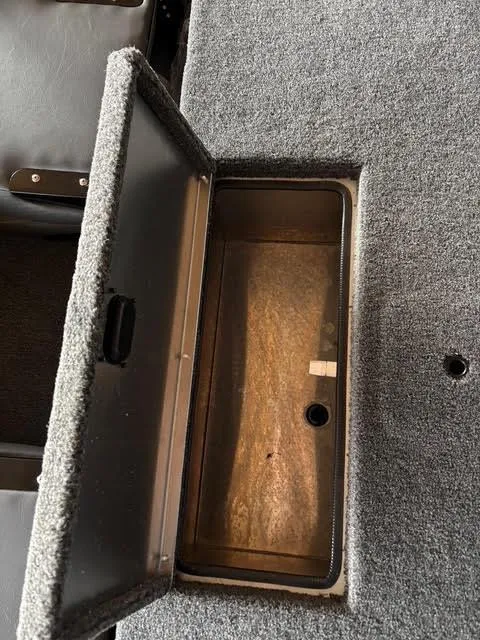 Slide: The Image of 2025 Lowe Skorpion 16 boat storage compartment with open lid, showcasing interior space. - 12