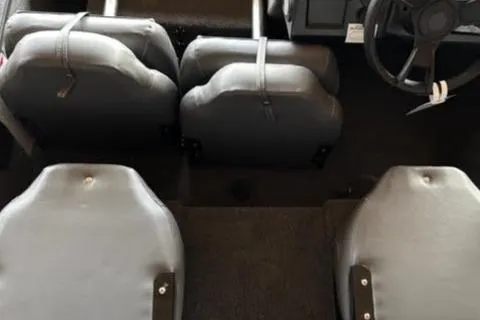 Slide: The Image of Interior view of 2025 Lowe Skorpion 16 boat, featuring four gray seats and steering wheel. - 18