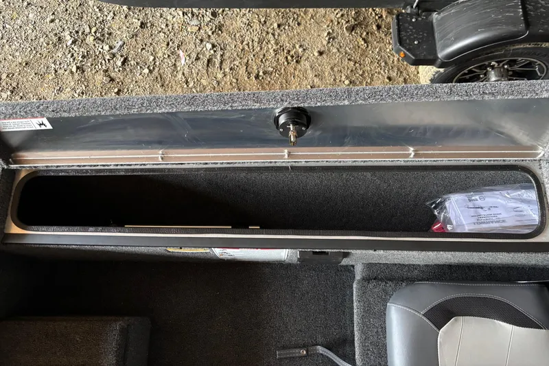 Slide: The Image of 2025 Lowe Skorpion 16 boat interior storage compartment with carpeted finish and seating. - 19