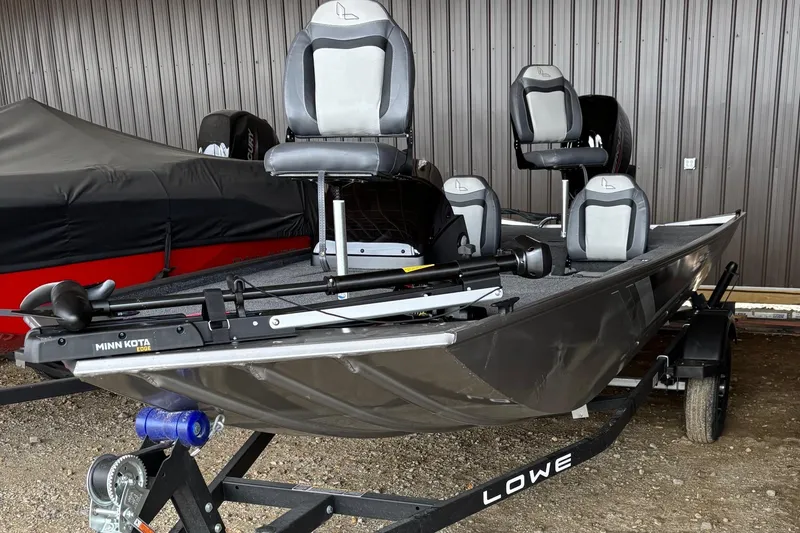 Slide: The Image of 2025 Lowe Skorpion 16 fishing boat on trailer, featuring comfortable seating and modern design. - 2