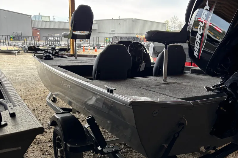 Slide: The Image of 2025 Lowe Skorpion 16 boat with Mercury engine in a storage area. - 4