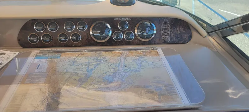 Slide: The Image of 1998 Sea Ray 450 Sundancer dashboard with navigation map and gauges. - 11