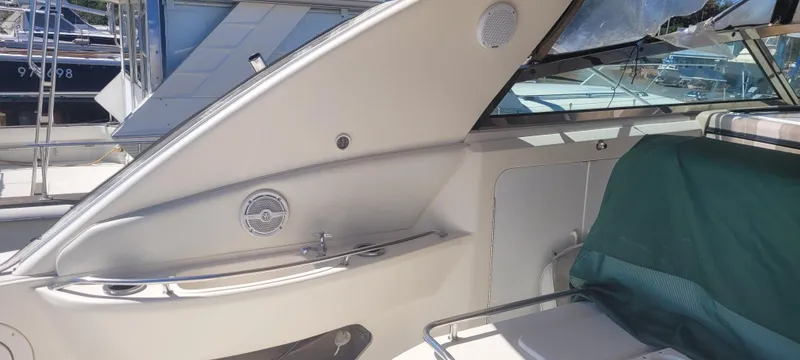Slide: The Image of 1998 Sea Ray 450 Sundancer boat interior with seating and speaker system. - 13