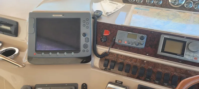 Slide: The Image of Control panel of a 1998 Sea Ray 450 Sundancer with navigation and communication equipment. - 14