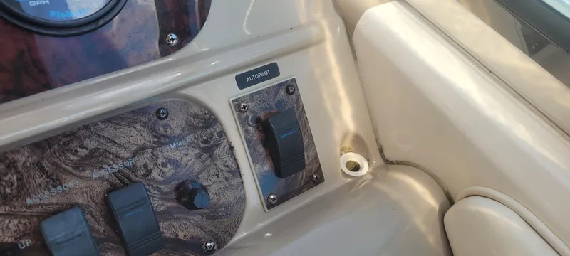 Slide: The Image of Control panel of a 1998 Sea Ray 450 Sundancer boat with switches and dials. - 16