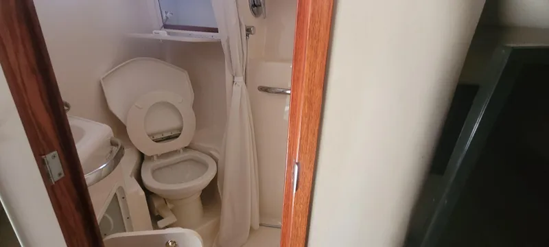 Slide: The Image of Bathroom interior of 1998 Sea Ray 450 Sundancer yacht, featuring toilet and shower. - 20