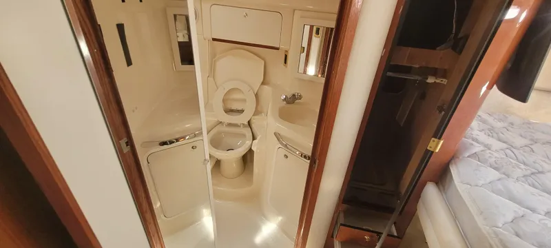 Slide: The Image of 1998 Sea Ray 450 Sundancer yacht bathroom interior with toilet and sink. - 28