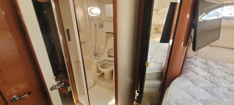 Slide: The Image of Interior of 1998 Sea Ray 450 Sundancer showing bathroom and bedroom with modern amenities. - 29