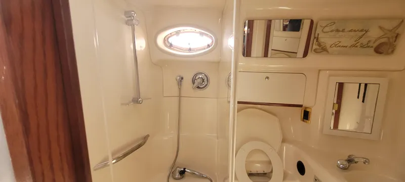Slide: The Image of Bathroom interior of 1998 Sea Ray 450 Sundancer yacht, featuring shower and toilet. - 30