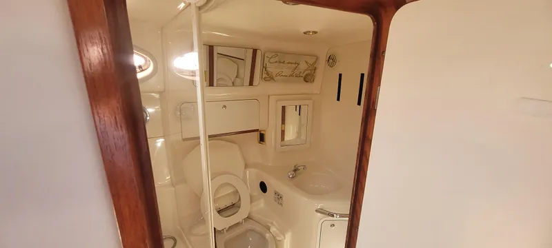 Slide: The Image of Bathroom interior of 1998 Sea Ray 450 Sundancer yacht, featuring toilet and sink. - 32
