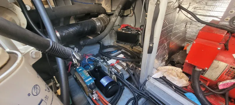 Slide: The Image of Engine room of a 1998 Sea Ray 450 Sundancer with visible wiring and components. - 46
