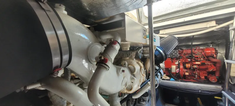 Slide: The Image of Engine room of a 1998 Sea Ray 450 Sundancer with visible components and machinery. - 47