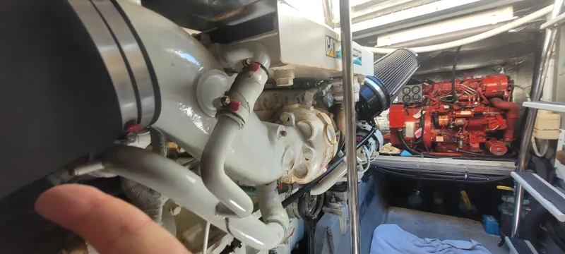 Slide: The Image of Engine room of a 1998 Sea Ray 450 Sundancer, showcasing mechanical components and equipment. - 48