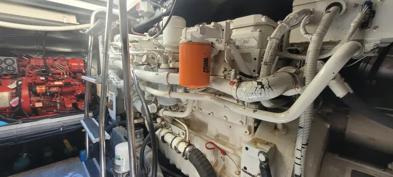 Slide: The Image of Engine room of a 1998 Sea Ray 450 Sundancer with visible machinery and components. - 49
