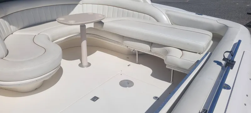 Slide: The Image of 1998 Sea Ray 450 Sundancer boat interior with white seating and table. - 8