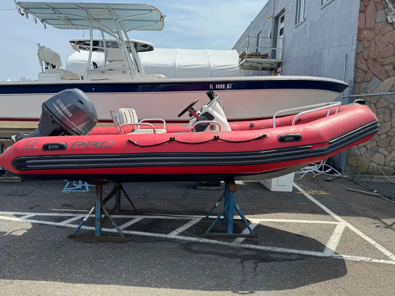 Slide: The Image of 2019 Zodiac Bayrunner 500 inflatable boat in red, parked on a stand outdoors. - 10