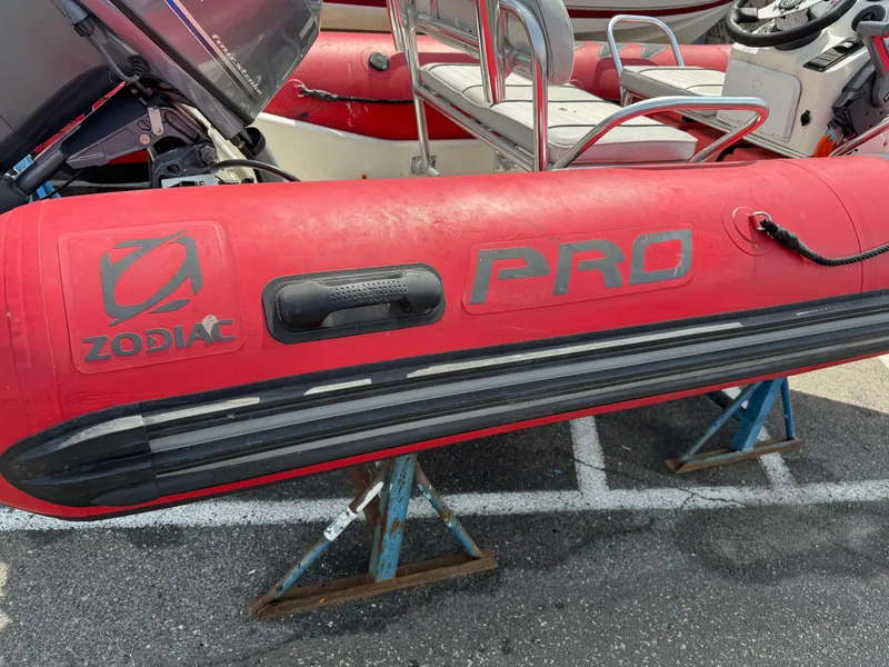 Slide: The Image of Red Zodiac Bayrunner 500 inflatable boat, 2019 model, displayed on stands in a parking lot. - 12