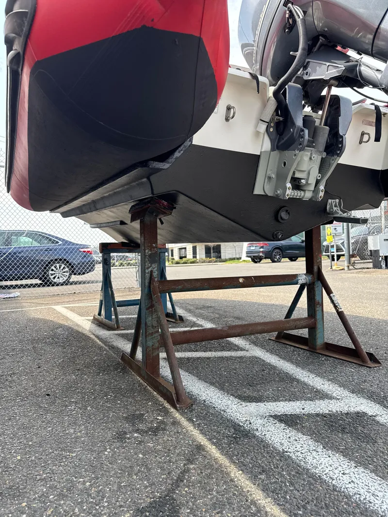 Slide: The Image of 2019 Zodiac Bayrunner 500 boat on metal stands in a parking lot. - 6
