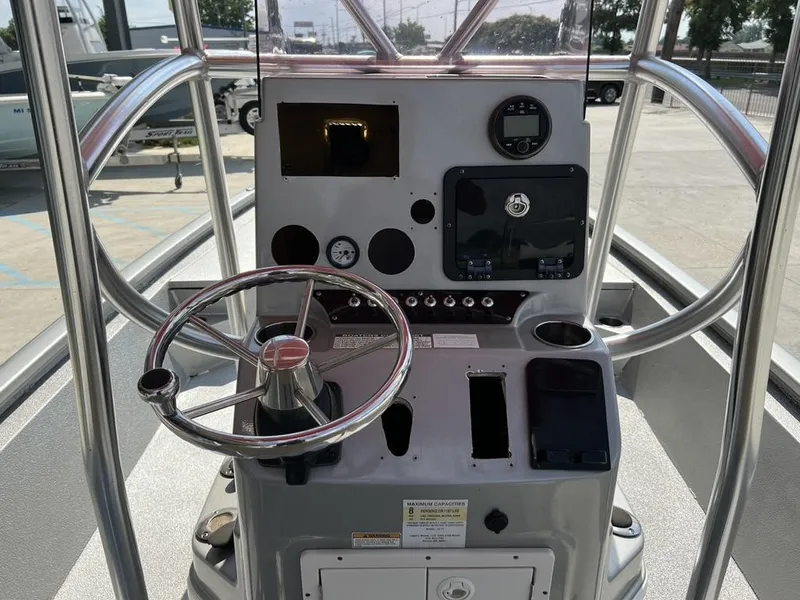 Slide: The Image of 2020 Avid 23 FS Platinum boat console with steering wheel and controls. - 1