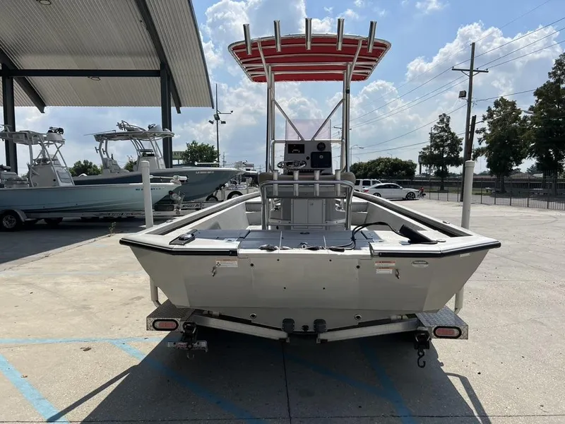 Slide: The Image of Avid 23 FS Platinum 2020 boat on trailer, parked outdoors under a canopy. - 10