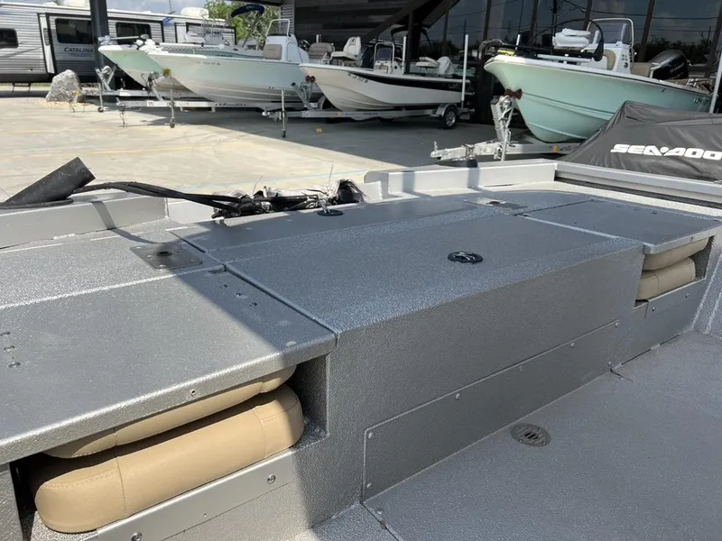 Slide: The Image of 2020 Avid 23 FS Platinum boat interior with storage compartments and seating. - 2