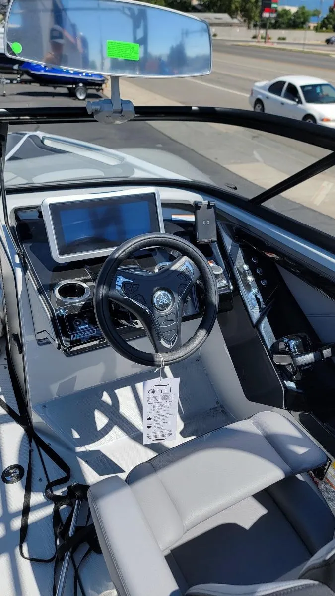 Slide: The Image of 2024 Yamaha Boats 255XD dashboard with steering wheel and digital display. - 2