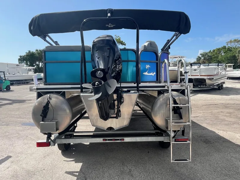 Slide: The Image of 2024 Lexington 17 Emerg pontoon boat, rear view with motor and ladder. - 3