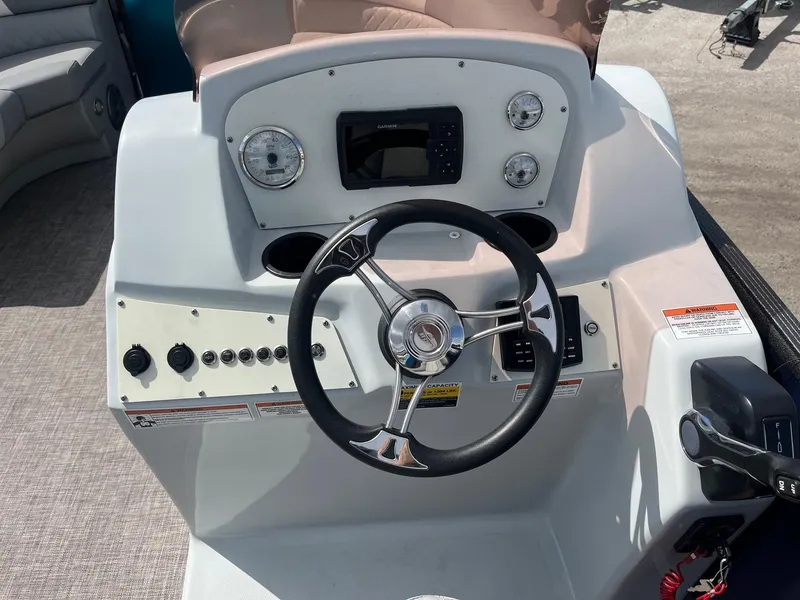 Slide: The Image of 2024 Lexington 17 Emerg boat dashboard with steering wheel and control panel. - 4